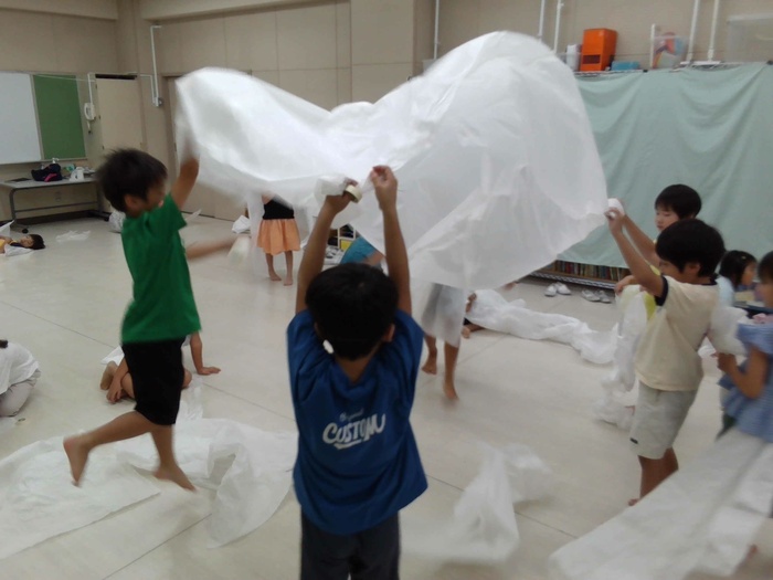 友達と一緒に薄葉紙をふわっとさせている様子