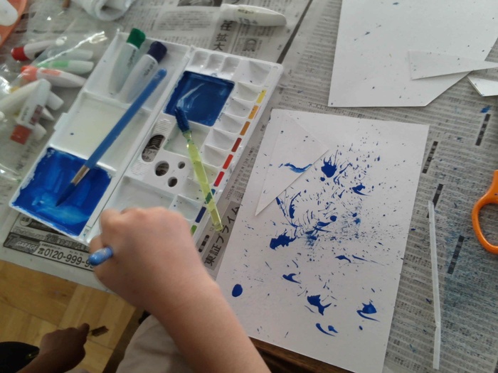 画用紙に絵の具を飛ばす様子。