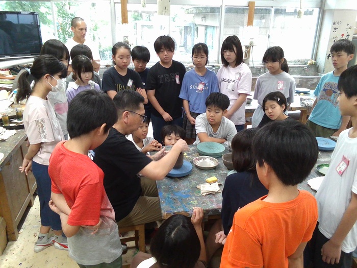 先生が茶碗づくりのお手本を見せている様子